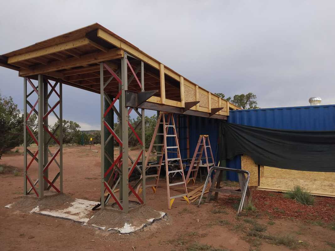 Steel beams and shipping container during the house build